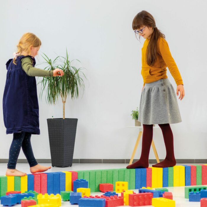 Kinder laufen auf XXL Bausteine mit Noppen