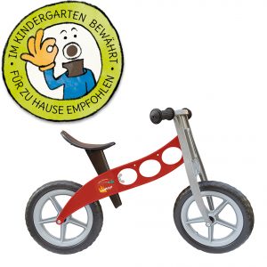 Foto: rotes Kinder-Laufrad "Feuerwehr" neben Grafik "Im Kindergarten bewährt - für zu Hause empfohlen"